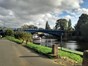 A footpath follows the winding River Severn through the Georgian town of Stourport-on-Severn, with a view of the river to the left and the river bridge in the distance.