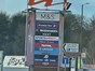large retail park sign with multiple shop signs