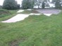 A grassed area surrounds the BMX track which has a course that contains a series of rolling jumps and turns.
