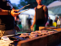 Blurred picture of a hand holding utensils cooking at a barbeque