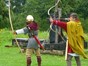 two people dressed up as Roman archers with bows and arrows