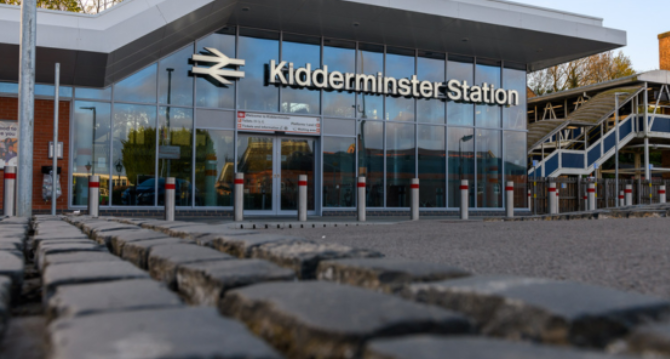 Glass fronted Kidderminster train station  with cobbled area at the foreground