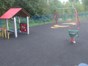 Younger children's play area with beightly coloured den areas and painted games on the soft surface floor covering.