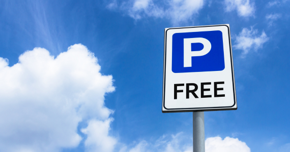 Free parking sign on a blue sky with clouds