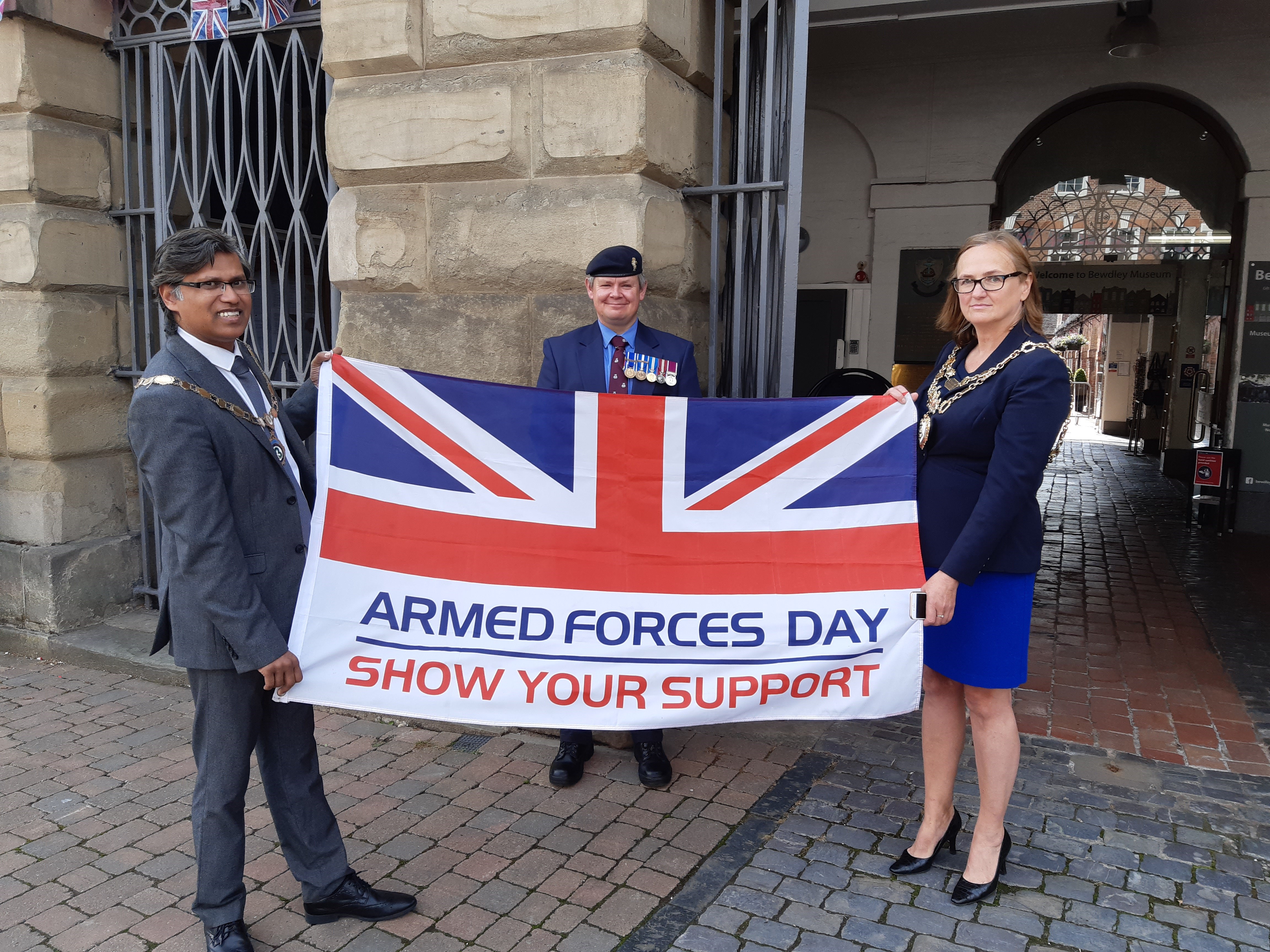 Wyre Forest District Council’s Chairman Councillor Shazu Miah, veteran Stuart Patterson and Mayor of Bewdley Councillor Anna Coleman flying a flag
