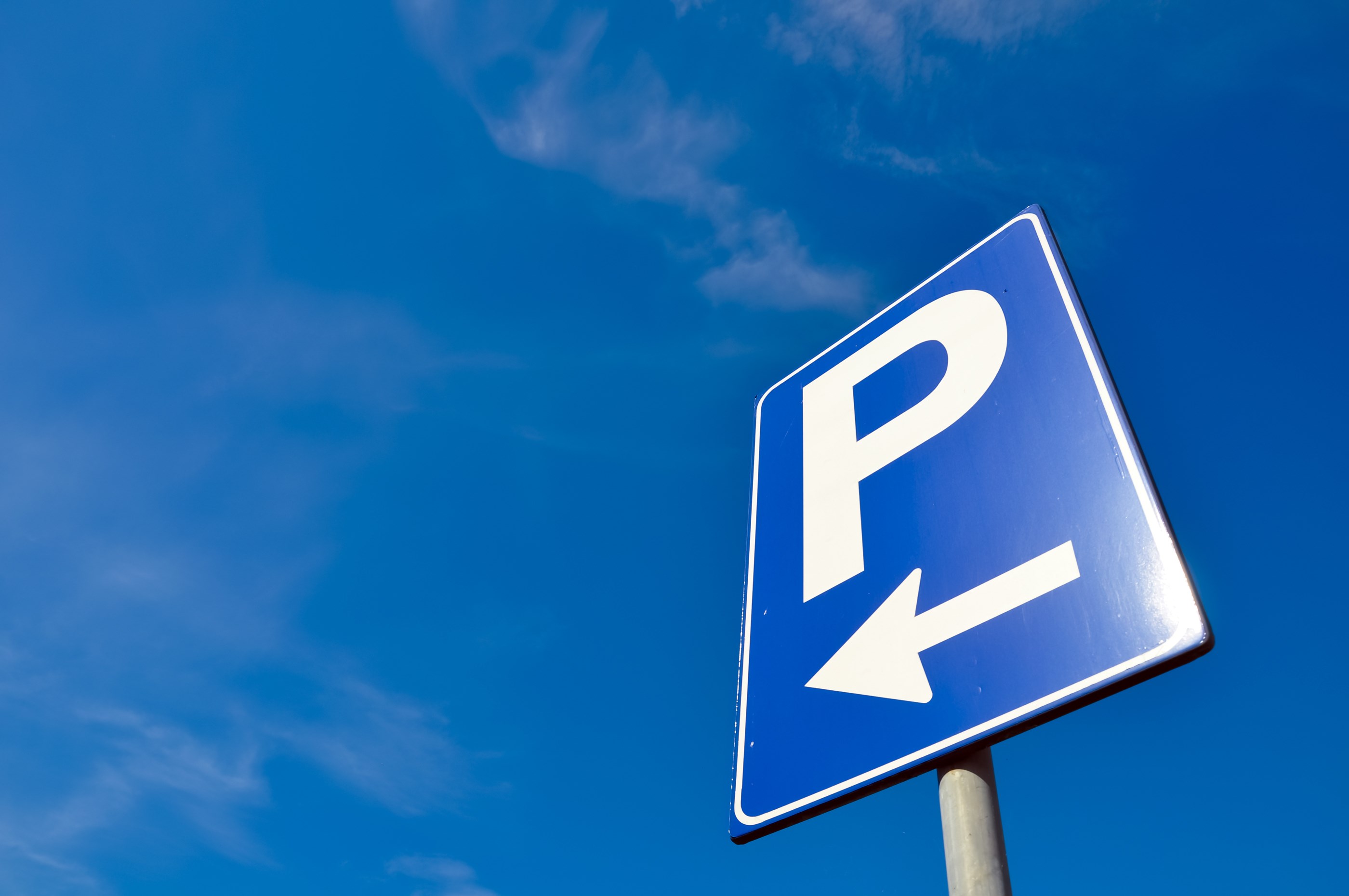 Parking sign with blue sky background