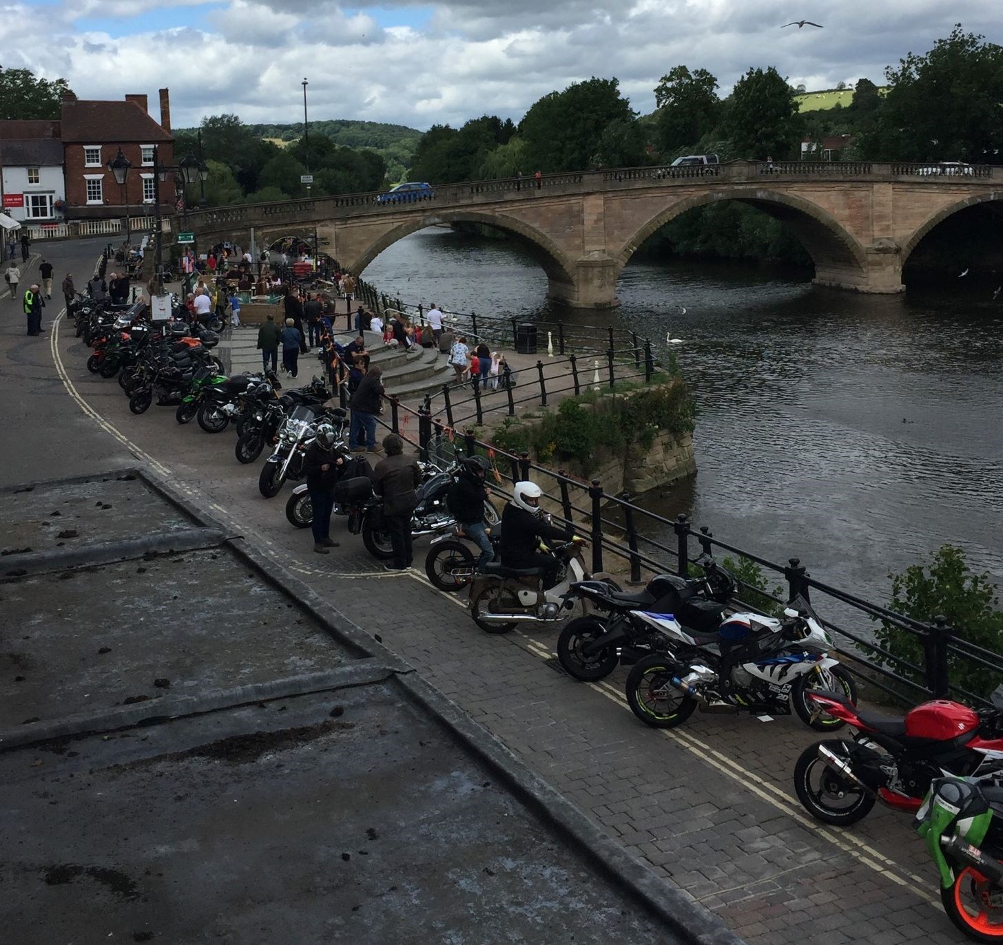 several motrbikes parked alongside River severn on footpath in Bewdley Town Centre