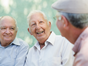 three elderly men smiling