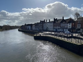 river and south bank on right with road and buildings