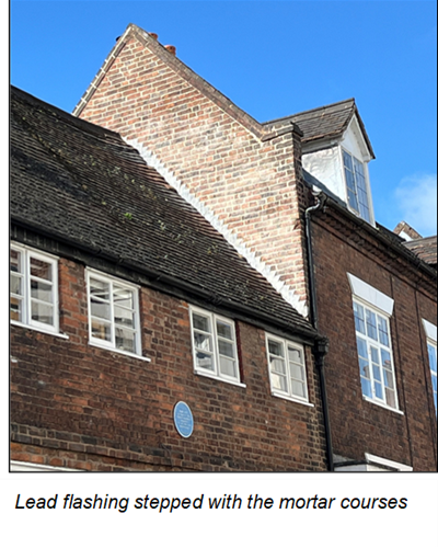 close up on roof of 2 adjoining brick buildings