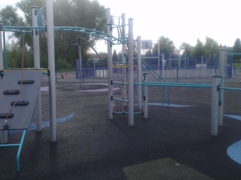 Children's climbing frame across multiple levels and stretching vastly across the play area on the soft surface floor covering. Located centrally in the public park.