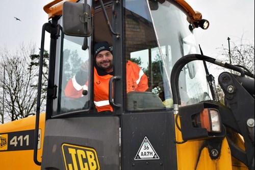 man in high vis in JCB