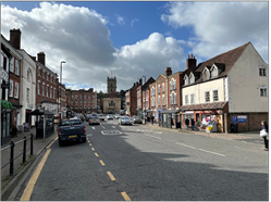 street leading to church in centre buildings flank both sides of the street