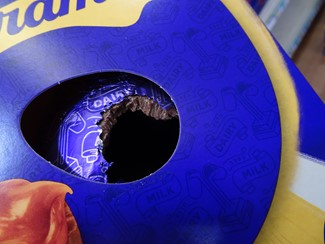 Image of an Easter Egg packaging. The egg and foil have been gnawed by rodents.