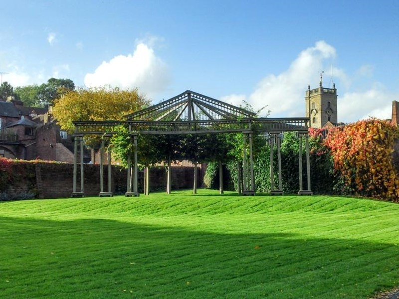 An outdoor wooden framed theatre located in the far corner of the public gardens. It is green and takes it's name of the Green Theatre. Behind the open-framed theatre are high pre-war walls which providea solid backdrop to the open air theatre.