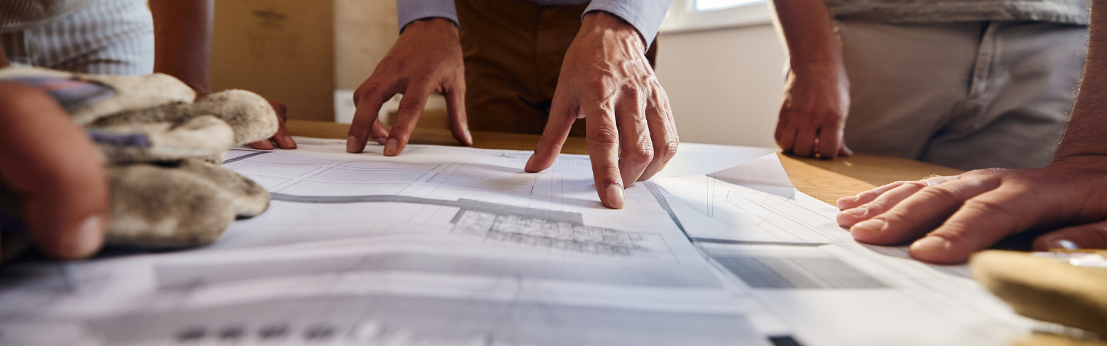 close up on hand pointing to architectural drawing