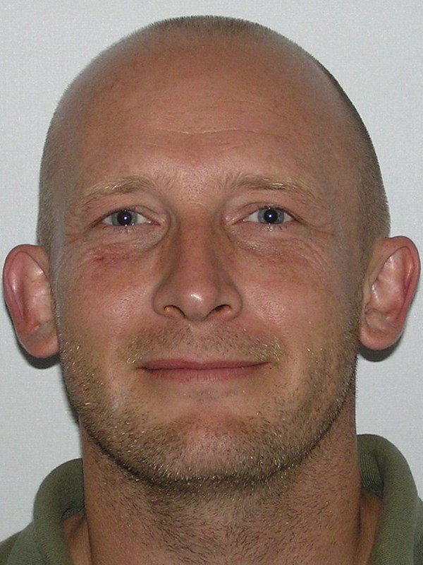 headshot of a bald man
