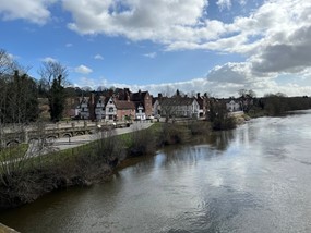 river with path on left bank and buildings beyond
