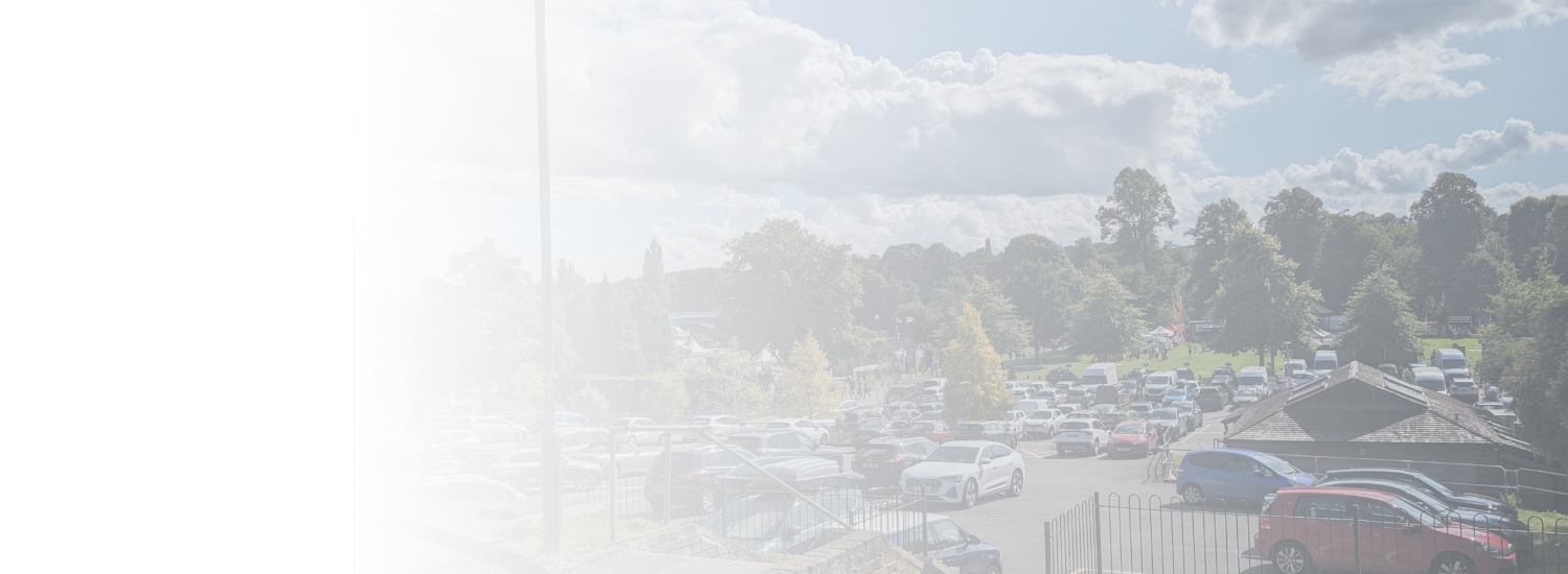 gradient fade of full car park by trees and grass