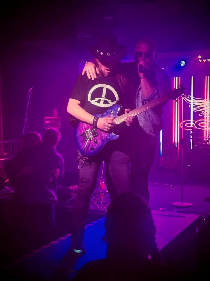 Band member on stage playing the guitar