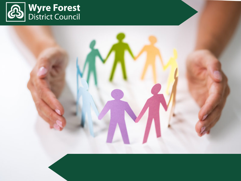 paper cutoout people surround by a pair of hands