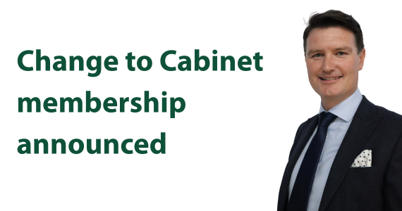 Man with dark hair in a suit. Wording says Change to Cabinet membership announced.