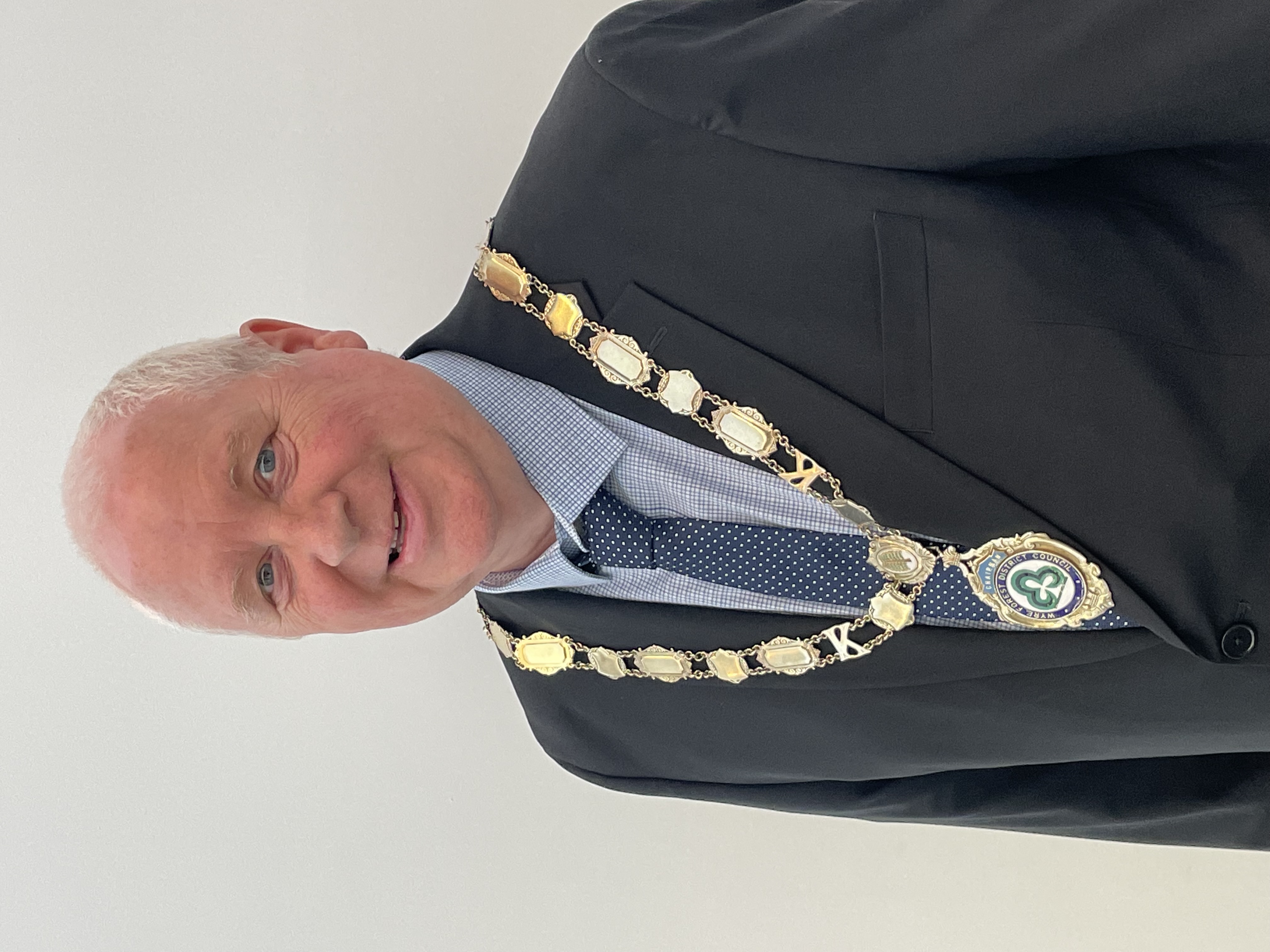 Headshot of male wearing chairman of the council chains and blue suit