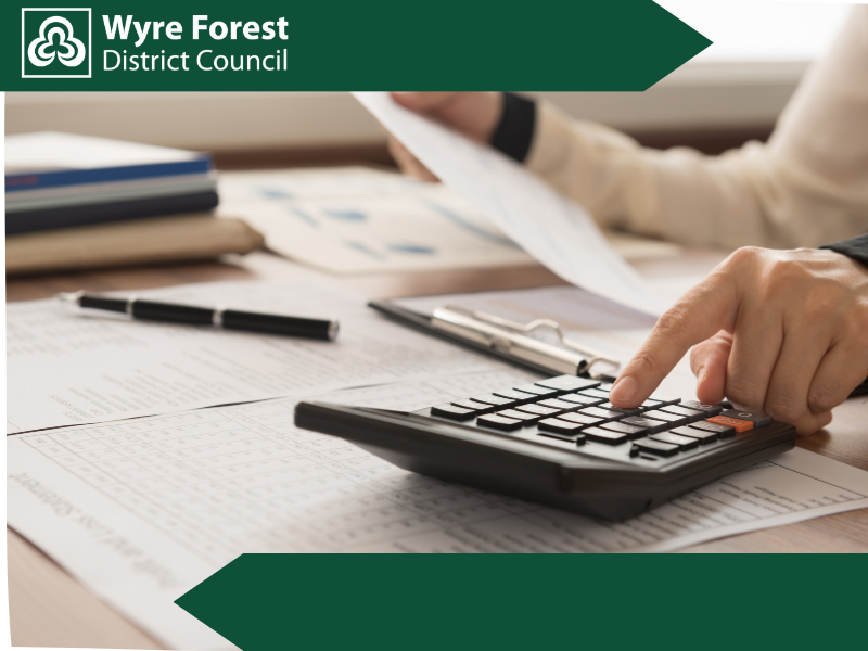 A person at a desk using a calculator