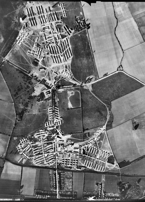 black and white ariel photograph of fields and old military buildings