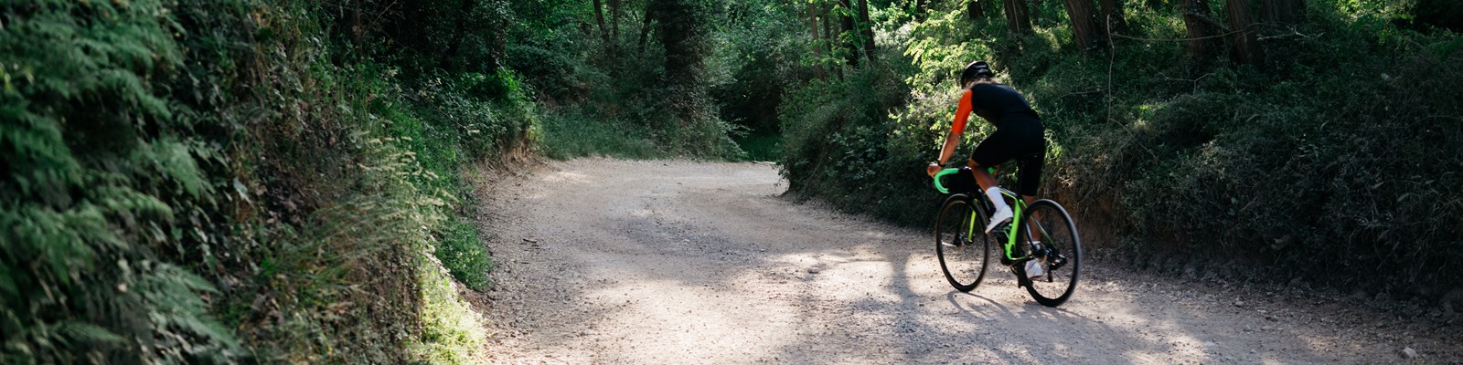 cyclists riding bikes through open meadow countryside