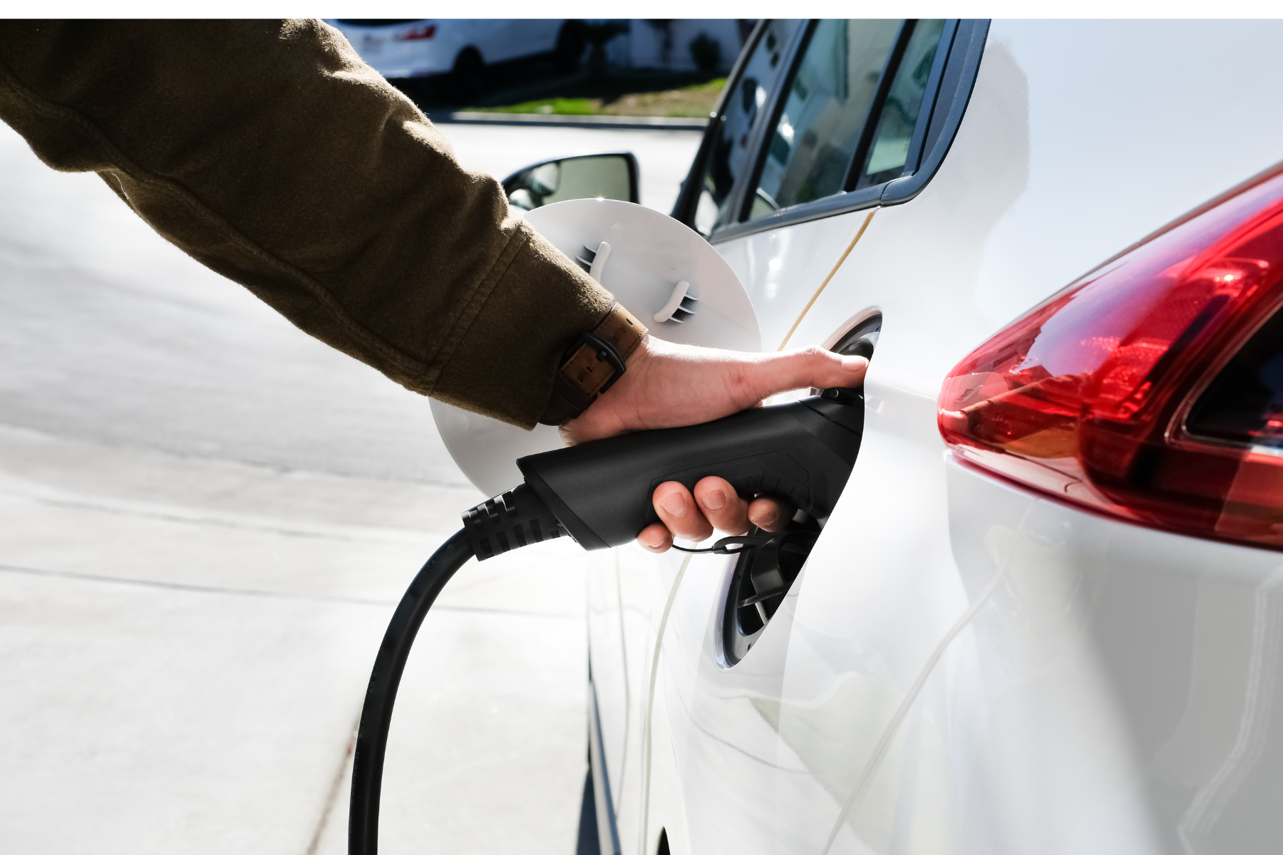 A person charging an electric vehicle 