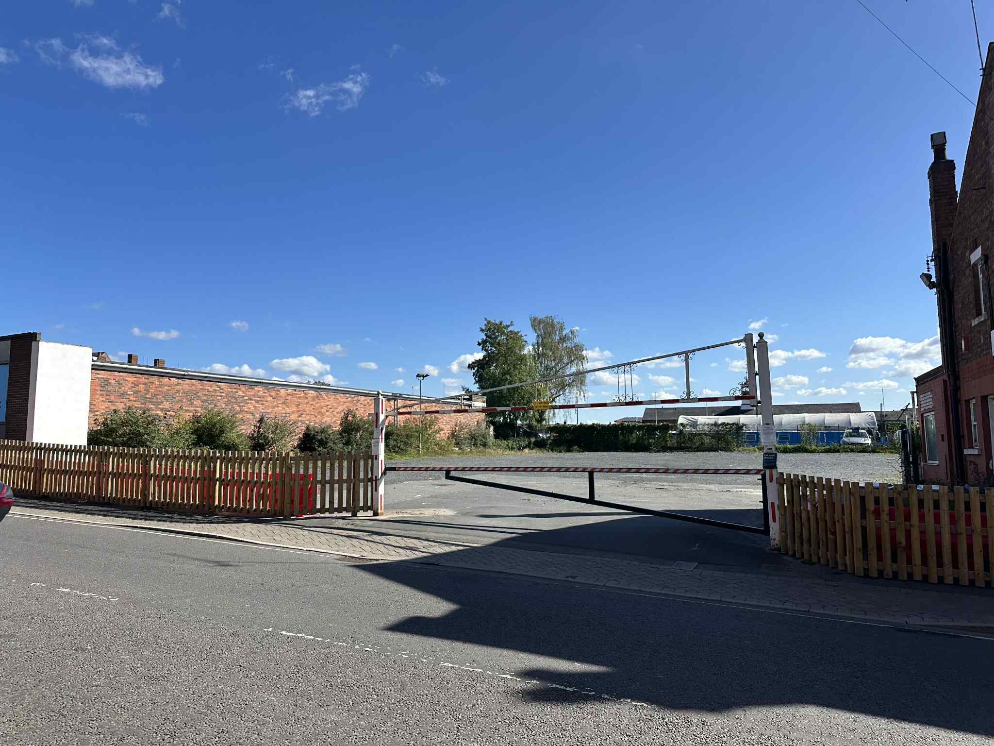 An empty car park with barriers up to prevent entry