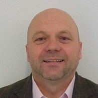 headshot of bald man