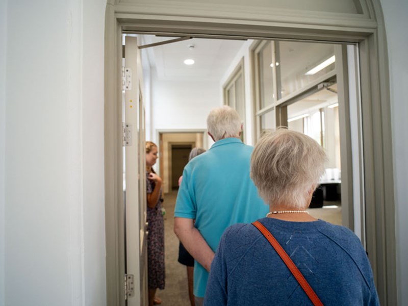 A group of people walking along a corridor