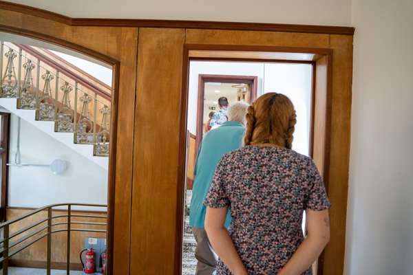 A group of people walking along a corridor at The Old Court