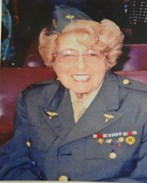 smiling woman in full military uniform