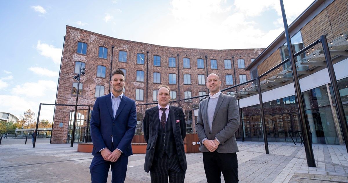 Three people stood outside Piano Building