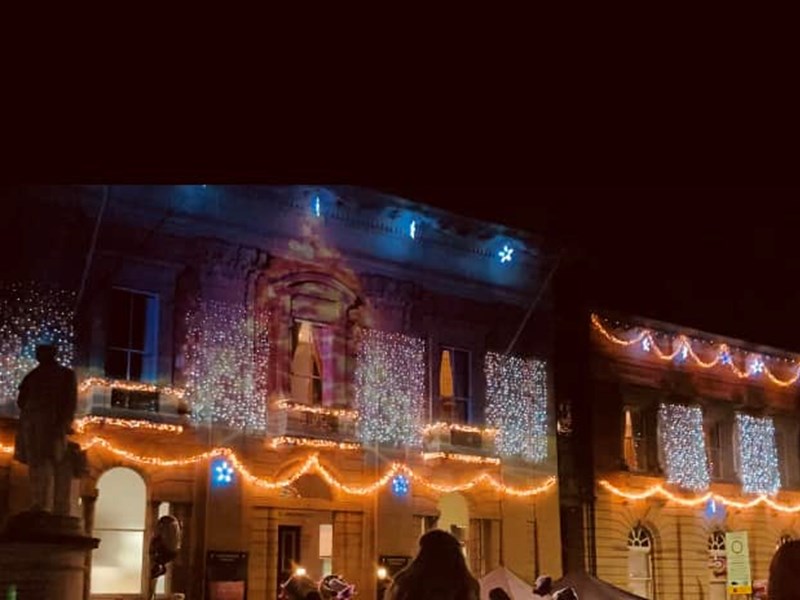The front of Kidderminster Town Hall decked in a range of coloured christmas lights