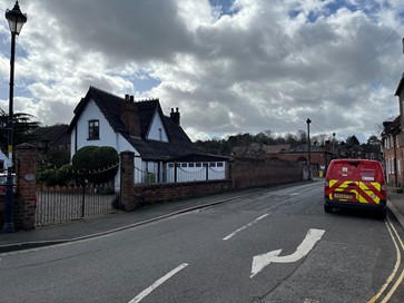 whitewashed cottage on road