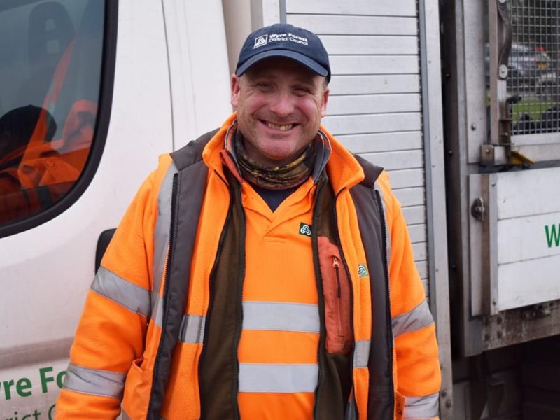 smiling man in front of van