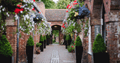 Image of path at Bewdley Museum with hanging baskets and brick archways