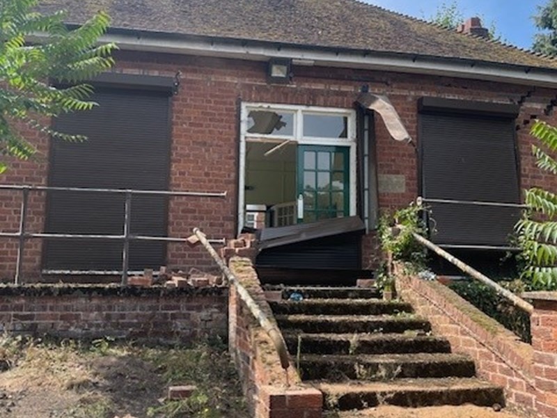 steps leading up to a derelict single storey building