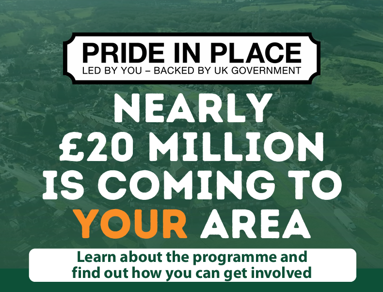 A promotional banner with an aerial view of a town in the background. Large text reads “Pride in Place – Led by you, backed by UK Government.” Below, bold text says “Nearly £20 million is coming to your area,” with “your” highlighted in orange. At the bottom, smaller text reads “Learn about the programme and find out how you can get involved.”