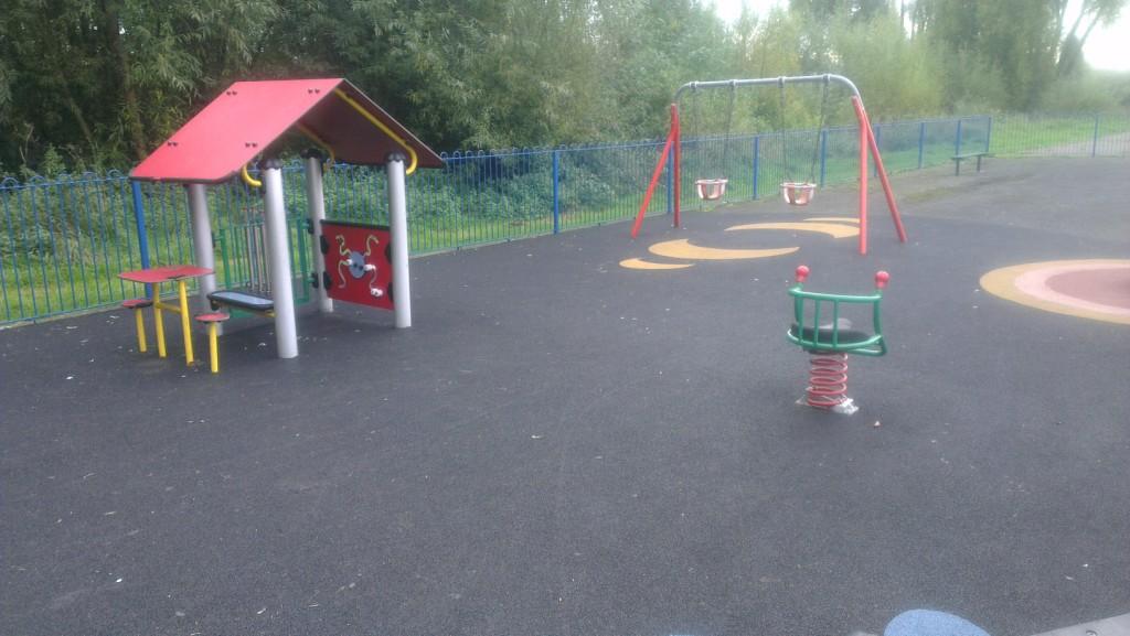 Younger children's play area with beightly coloured den areas and painted games on the soft surface floor covering.