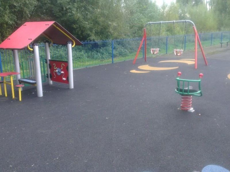 Younger children's play area with beightly coloured den areas and painted games on the soft surface floor covering.