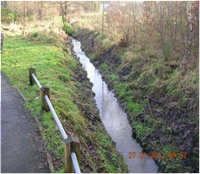 a watercourse (brook) on the left of a road