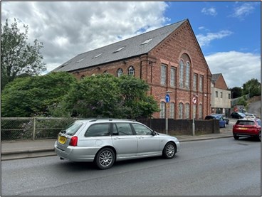 large brick building close to side of road
