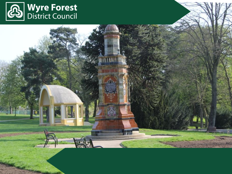 A monument and bandstand in a park 