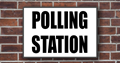 Brick wall with polling station sign
