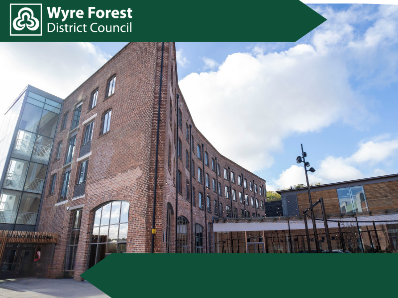 A large red brick building shaped like a piano